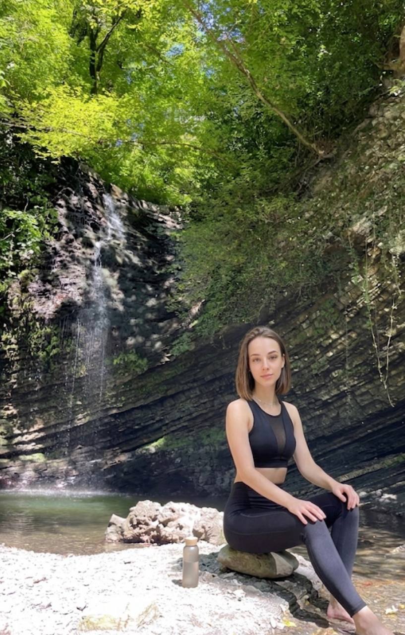 Mila taking a calm movement break beside a waterfall